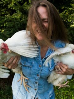 happy owner holding two chickens